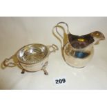 Hallmarked silver tea strainer and bowl by Mappin and Webb, together with a silver cream jug, approx