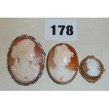 Three old shell cameo pendants/brooches, one set in gold, another silver