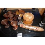 Treen 19th c. turned wood egg cups, two candlesticks, four tots, yew wood box and a bird whistle