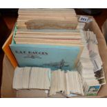 Box containing cigarette card albums and loose cigarette cards