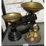 Set of old brass bell weights on cast iron stand and set of brass and iron kitchen scales