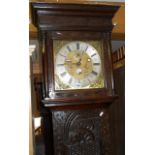 18th c. 8 day Grandfather clock in a Victorian carved oak case. Brass face and silver chapter ring