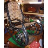 Ebonised bentwood rocking chair by Thonet with caned seat and back