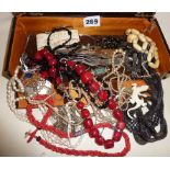 Assorted vintage and antique costume jewellery in case, some silver, red coral beaded necklace,