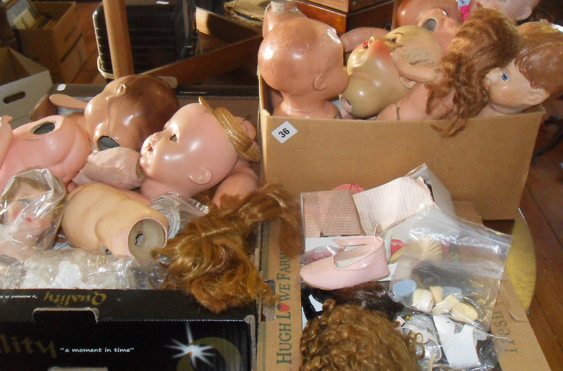 Large collection of doll's heads, limbs and wigs etc., inc. porcelain heads and assorted composition