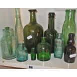 Early 19th c. green glass wine bottle and ten various other glass bottles