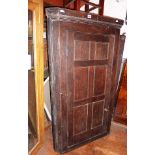 18th c. oak corner cupboard with panelled door enclosing shaped shelves