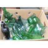 Collection of assorted green glass bottles and decanters