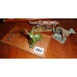 Two small bronze figures of dogs and a similar stylised fawn on wooden base stamped "Plasait,