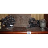 19th c. cast iron fireplace ornaments of a lion and a flower basket together with an iron relief