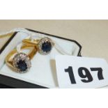 Two similar 18ct gold rings set with blue stones