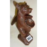 19th c. unusual Black Forest bear nutcracker on stand, with glass eyes and holding bowl to catch the