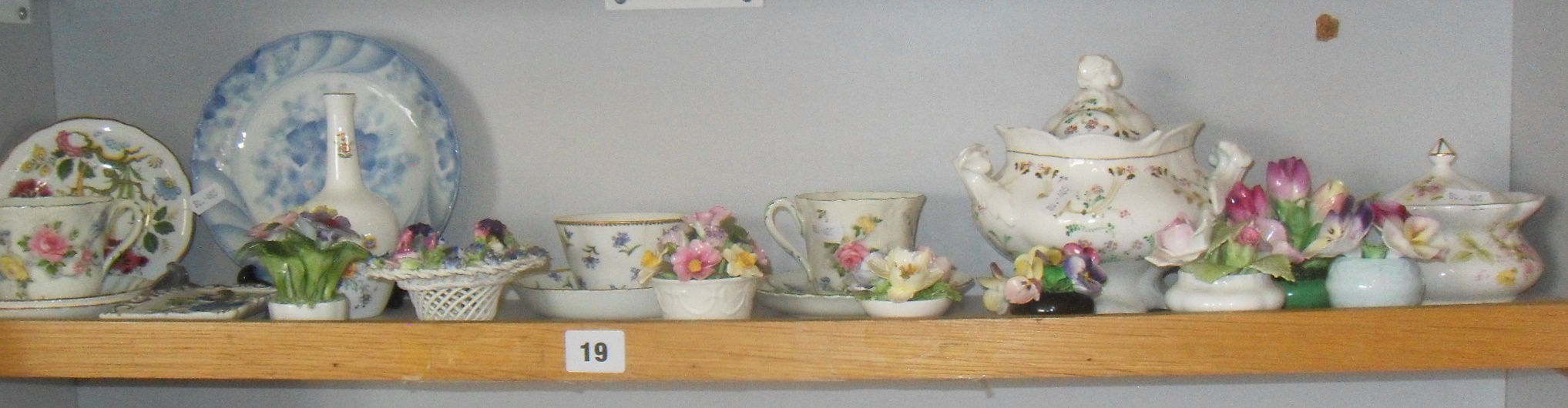 Shelf of assorted floral decorated china and china flower ornaments, etc.