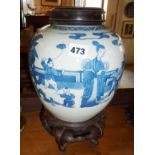 Chinese Kangxi style blue and white jar on carved hardwood stand with similar cover, 34cm tall