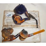 Three antique figural Meerschaum pipes, two with silver collars and one with case