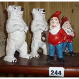 Two painted cast iron polar bears and two similar gnomes