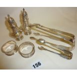 Hallmarked silver sugar tongs, silver pepperettes, napkin rings, etc., approx 3.5 troy oz