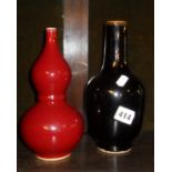 Chinese red glazed double gourd vase and a black glazed bottle vase with four character marks