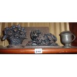 19th c. cast iron fireplace ornaments of a lion and a flower basket together with an iron relief