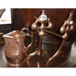 Pair of Art Nouveau copper firedogs and an Arts & Crafts copper ale jug with lid