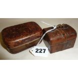 Two leather-covered travel inkwells, one in the form of a miniature trunk