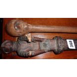 Tribal Art: African hardwood walking stick with carved head handle and glass eye and another African