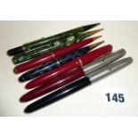 Two Parker 51 fountain pens, another Parker pen and pencil set, marbled propelling pencils etc.