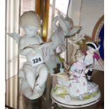 Two Lladro cupids playing instruments (A/F), and a Continental porcelain group