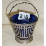 Pierced silver bucket-shaped salt, with blue glass liner. Hallmarked for London 1910 Carrington &