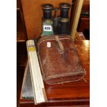 Pair of field glasses in leather case and a slide rule