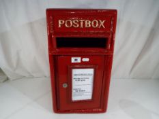 A red cast iron post box.