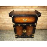 A good quality unusual walnut veneered drinks cabinet on casters with brass detailing and drop down