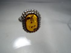A silver ring stone set with amber.