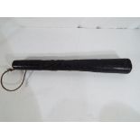 A highly carved ebony truncheon, approximately 38 cm (l).