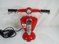 A red lamp in the form of a Lambretta scooter,