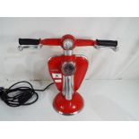 A red lamp in the form of a Lambretta scooter,