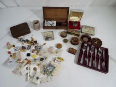 A quantity of advertising pin badges, vintage tins,