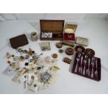 A quantity of advertising pin badges, vintage tins,