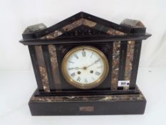 A French black slate and marble mantel clock of architectural form with pendulum and key, 30.