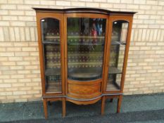A good quality bow fronted display cabinet with detailed inlay,