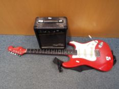 An Encore electric guitar in red and white with a Gorilla GG-20 amp.