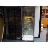 A twin door glass display cabinet 170 cm x 67 cm x 36 cm (light coloured cabinet to the right of