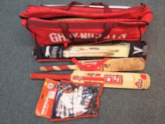 A Gray-Nicolls cricket bag containing a quantity of cricket equipment to include bats,