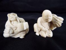 Two late 19th century ivory netsuke one in the form of a seated man holding a basket of fish and