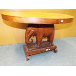 A good quality African hardwood table carved in the form of an elephant,