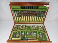 A retro style canteen of cutlery containing a quantity of Argyle plated cutlery and Sanderson bone