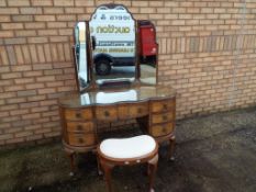 A good quality walnut veneer kidney shaped dressing-table with three piece mirror and stool,