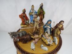 An American Tourister vintage travel case containing figures from a nativity scene - This lot MUST