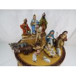 An American Tourister vintage travel case containing figures from a nativity scene - This lot MUST