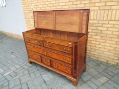 An oak inlaid bedding chest with four drawers and hinged lid, approximately 91 cm x 143 cm x 55 cm.